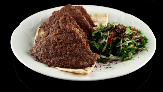 Grilled meat cutlets stuffed with cheese, pistachios on the pita bread, loop