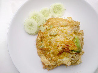 Thai-Style Omelet (Khai Jiao), Omelet with vegetables in white plate, It's popular traditional Thai style food