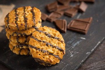 Glass of coffee with cookies on wooden background