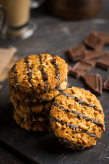 Glass of coffee with cookies on wooden background