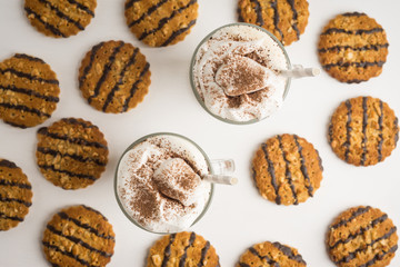 Glass of coffee with cookies on wooden background. Shallow depth of field.