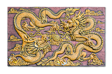 Fototapeta na wymiar Two Chinese style golden dragons fighting as low relief techniqu