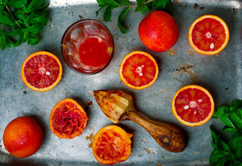 the fresh bloody oranges cut in half on a vintage metal tray.