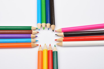 Close up picture of many little colored pencil crayons on white