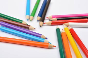 Fototapeta premium Close up picture of many little colored pencil crayons on white