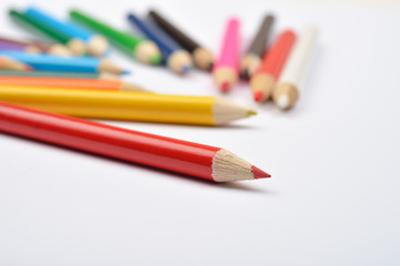 Close up picture of many little colored pencil crayons on white