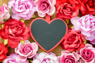 Fototapeta na wymiar Blank wooden tag heart shape with small roses.