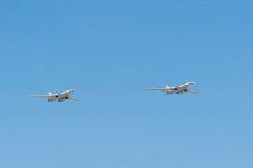 Fototapeta na wymiar 2 Tupolev Tu-160 (Blackjack) supersonic variable-sweep wing heavy strategic bomber fly on blue sky background 
