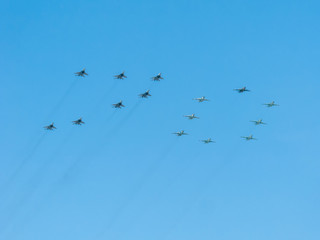 Number 70 made by 7 Mig-29 and 8 Su-25 on blue sky background
