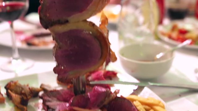 Closeup of a Picanha roast beef cut in Brazilian Steakhouse Restaurant with sword