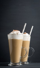 Coffee in glass on the wooden background