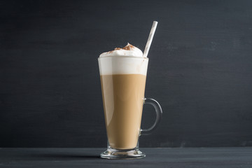 Coffee in glass on the wooden background