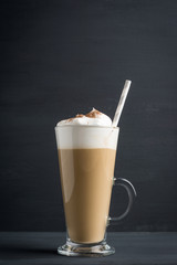 Coffee in glass on the wooden background