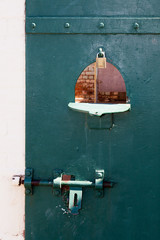 green cell door with peep hole