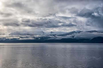 snowy Mountain range by norwegian fjord