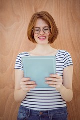 smiling hipster business woman on a tablet computer