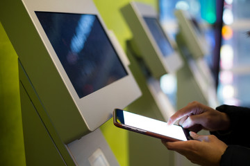 Woman using mobile phone for paying on vending system