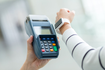 Woman using Smartwatch pay by NFC