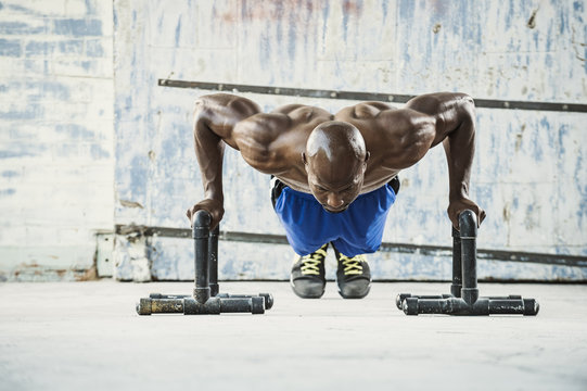 Man doing push ups in warehouse