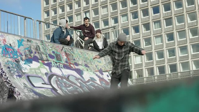 group of friends watching skater