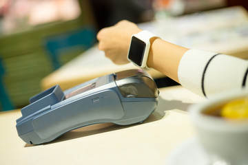 Smartwatch paying on the bill in restaurant