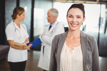 Portrait of smiling businesswoman in hospital