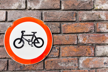 bicycle sign on brick wall 