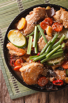 Dakjim braised chicken with vegetables in a Korean style close-up. vertical top view
