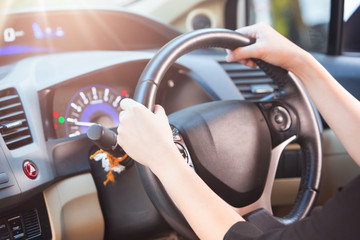 Women holding wheel and driving a car in a good time, selective