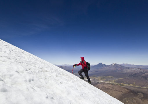 man climbing on glacier of Sajama Volcano in Bolivia