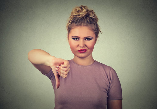 displeased angry pissed off woman annoyed giving thumbs down gesture