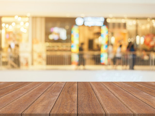 Wooden board empty table blurred background. Perspective brown wood over blur in department store - can be used for display or montage your products.Mock up for display of product.