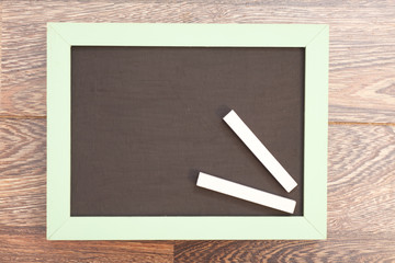 school wooden blank blackboard and white chalks