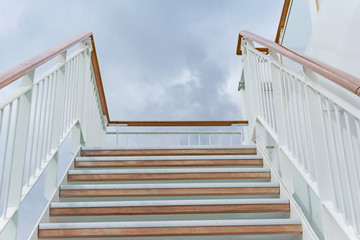 Wooden stairs against cloudy background
