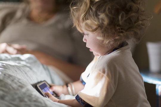 Caucasian boy playing with cell phone