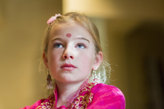 Caucasian girl wearing bindi on forehead