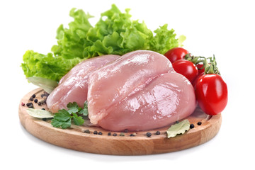 Fresh white chicken breast with tomato, salad and spices on a white background