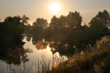 Fototapeta na wymiar Misty sunset on the river