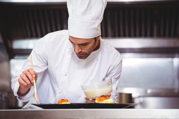 Chef putting sauce on a dish