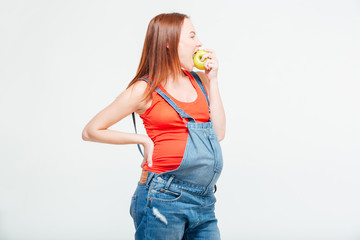 Pregnant woman eating apple
