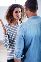 Obraz premium Young couple standing together and discussing after a fight