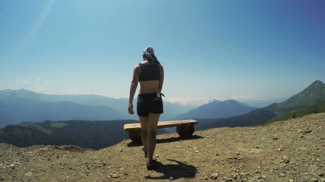 Girl on bench in mountains