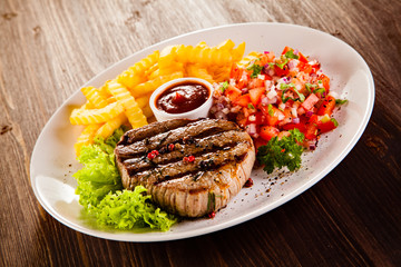 Grilled steak, French fries and vegetables 