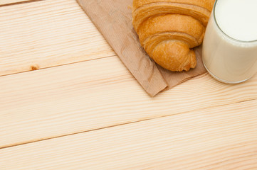 Fresh crispy croissant and glass of milk