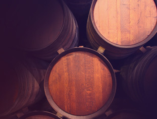 Row of wooden barrels of tawny portwine ( port wine ) in cellar, Porto, Portugal. Vintage old style