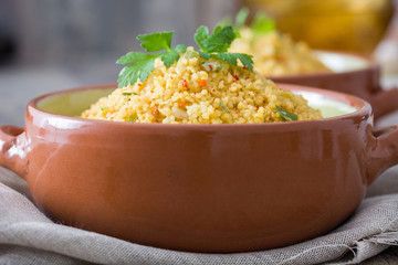 Couscous with vegetables on wood
