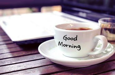 over light vintage  tone, cup coffee with text - good morning on the table [blur and select focus]