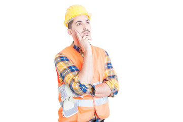 Young construction worker or engineer thinking and looking away