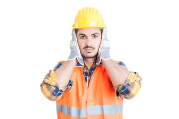 Hear no evil gesture with handsome engineer or constructor