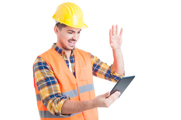 Happy engineer rising hand and salute while holding a tablet